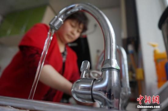 圖為4月13日,蘭州市七里河區(qū)居民李大媽用自來水洗菜。楊艷敏 攝
