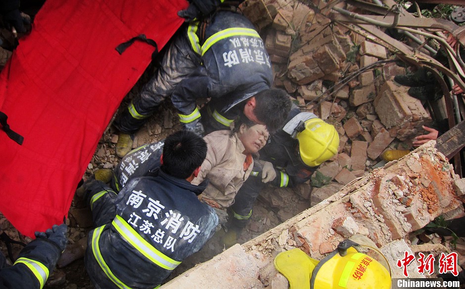 圖為南京消防隊員從廢墟中將傷者抬出。中新社發(fā) 梅亮 攝
