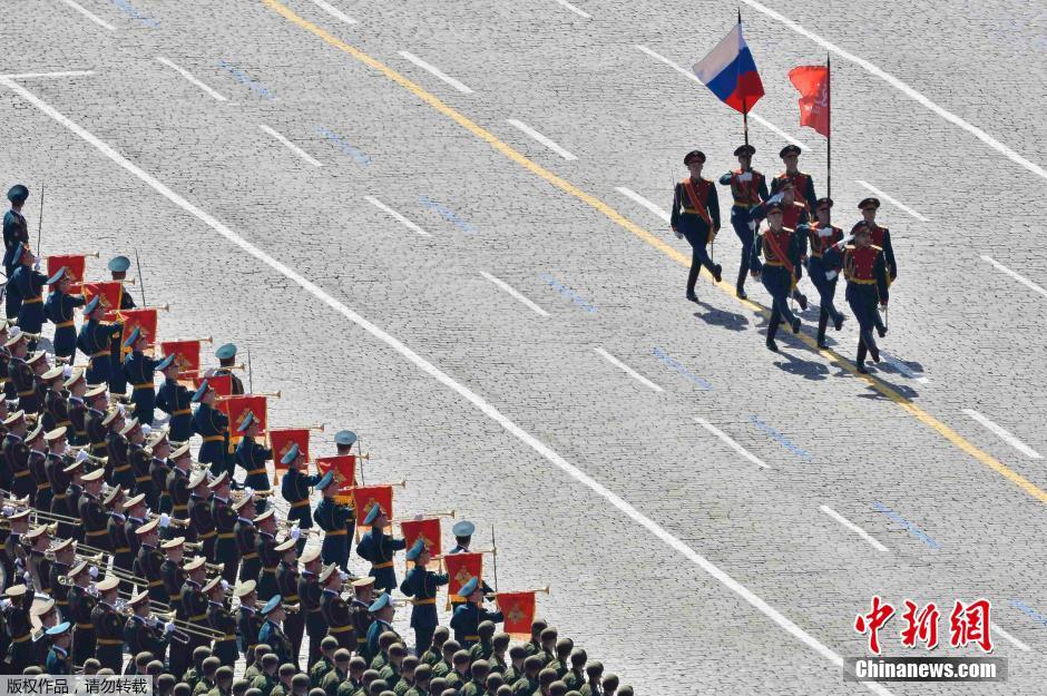 圖為俄羅斯國(guó)旗從受閱部隊(duì)前經(jīng)過(guò)。