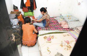 在米家崖一民房內，母親蹲在地上幫身陷傳銷的女兒穿鞋，但遭到女兒拒絕