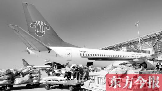 鄭州機(jī)場的工作人員在往飛機(jī)上裝貨 鄭州機(jī)場的工作人員在往飛機(jī)上裝貨