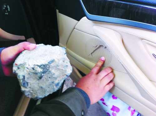 “飛”進(jìn)寶馬車內(nèi)的大石塊,將寶馬車的車門(mén)內(nèi)飾板砸爛。