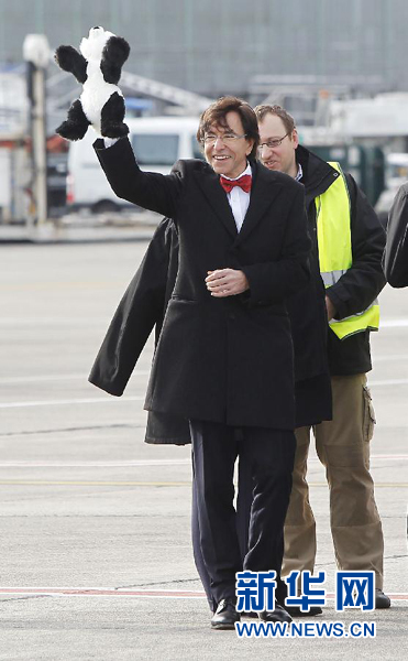 2月23日，在比利時(shí)首都布魯塞爾的國家機(jī)場，比利時(shí)首相迪呂波手舉熊貓玩具歡迎大熊貓“星徽”和“好好”