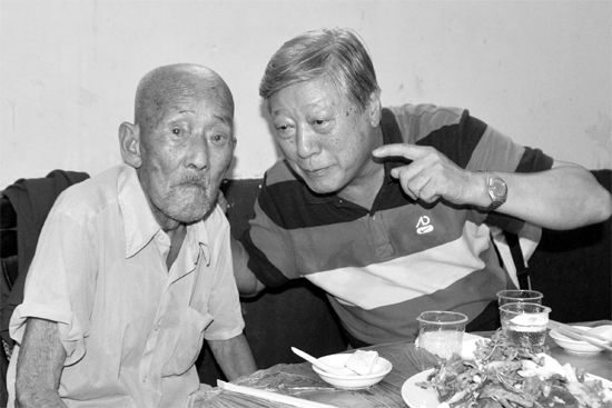 昨日，來自北京的英雄后代胡冠軍（右）專門趕到西平縣看望抗戰(zhàn)老兵孫殿修老人