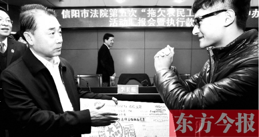 張立勇將依法執(zhí)行回來的農(nóng)民工工資發(fā)放給案件當(dāng)事人游昌華，游昌華施以中國傳統(tǒng)作揖禮答謝