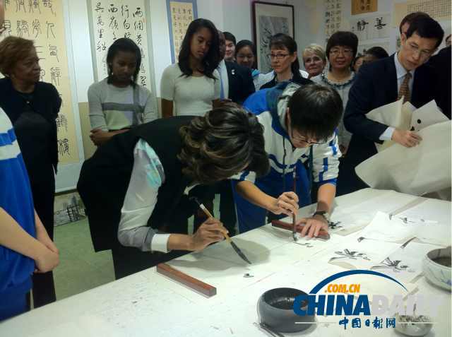 　北京時(shí)間3月21日，美國(guó)第一夫人米歇爾參觀北師大二附中時(shí)，與學(xué)生一起練習(xí)書法。