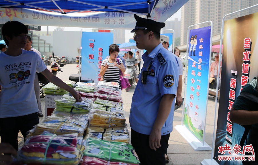 執(zhí)法人員勸導(dǎo)看守?cái)偽坏娜藛T搬離，停止非法占道經(jīng)營(yíng)。