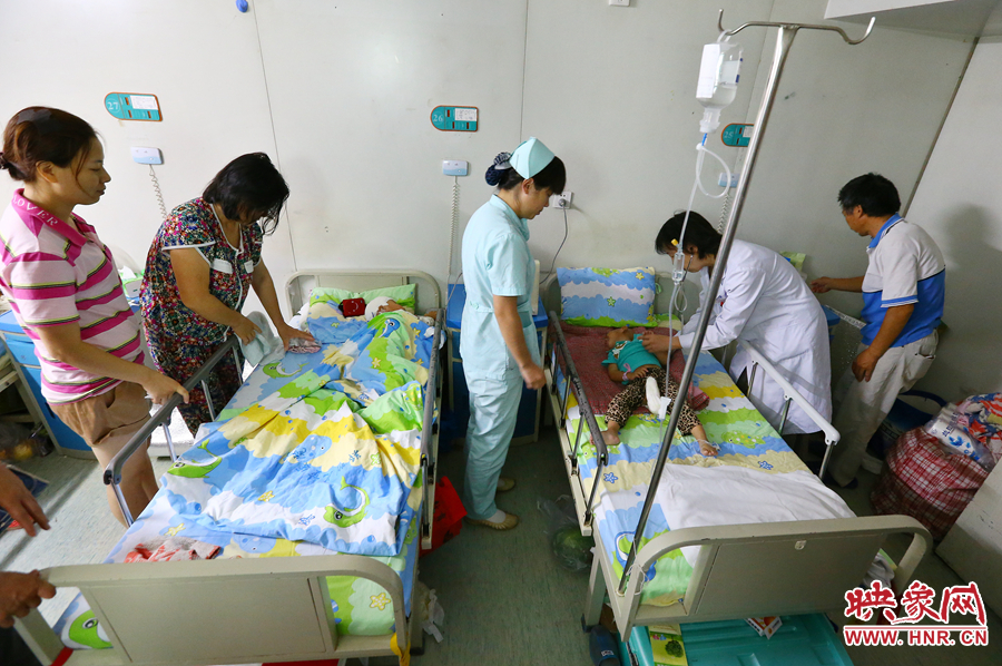 手術(shù)前，畫面右側(cè)的大龍正在接受醫(yī)生的檢查，左側(cè)的小龍還在熟睡。