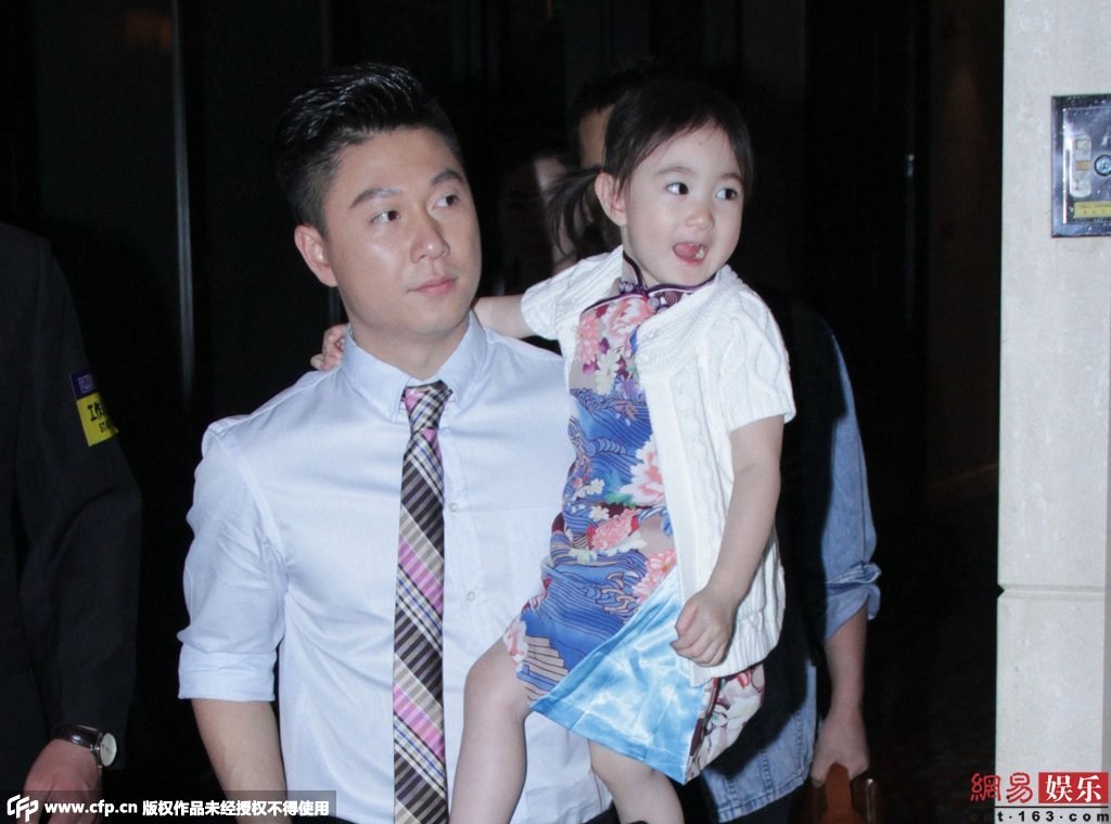 女兒奧莉身穿花旗袍配白色外套，還不停做表情賣(mài)萌搶鏡。