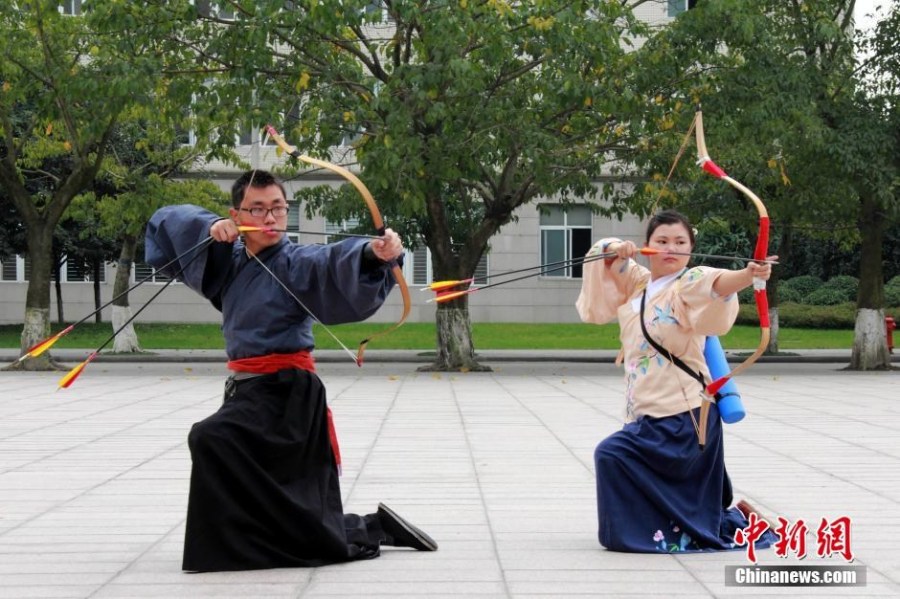 圖為課余練習(xí)射箭的“神雕俠侶”胡雅潔和胡默齋。