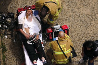 2日，救援人員在美國紐約地鐵事故車輛內(nèi)緊急疏散一名受傷乘客。圖/CFP