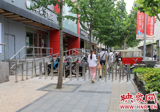 圖中道路左側(cè)的無障礙通道被鋼管隔離,右側(cè)的盲道也被侵占。